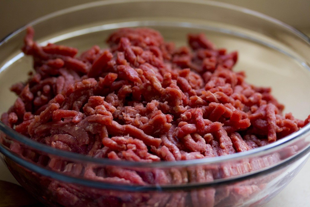Home cook preparing fresh raw rabbit meat cuts over a clean sink workstation