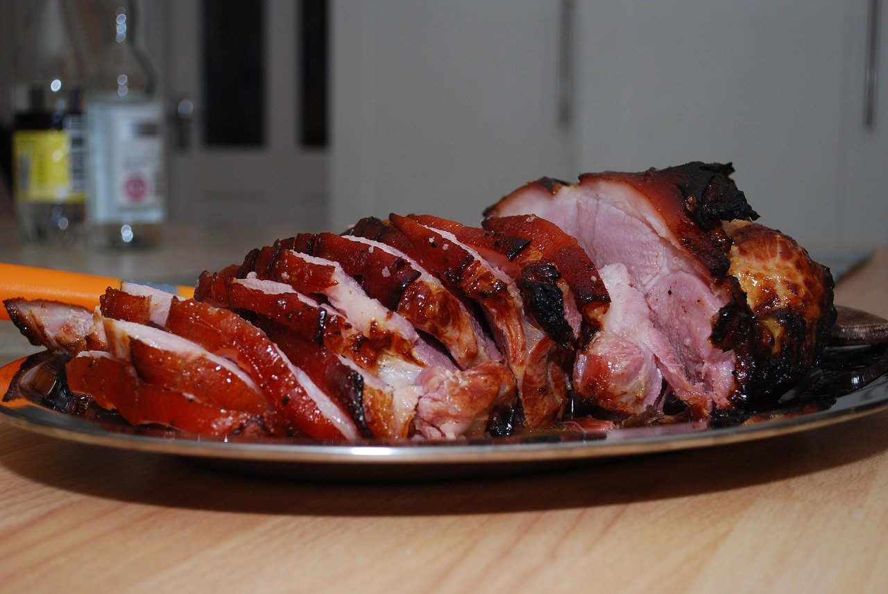 Sliced roasted rabbit saddle showing how to cook rabbit meat saddle tender and succulent on a wooden board